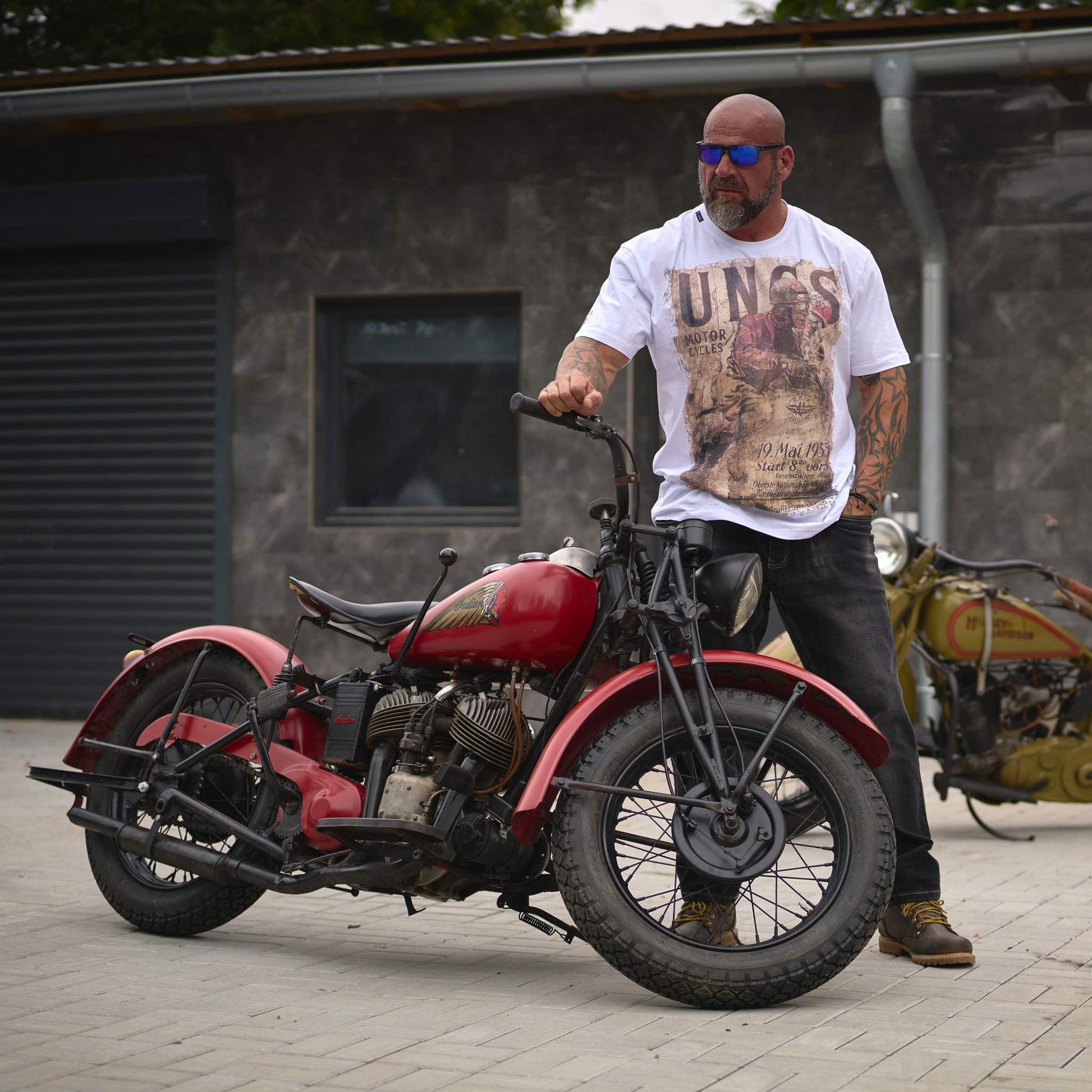 Man with motorcycle wearing UNCS clothing brand